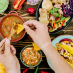 Mexican food table with hands grabbing food