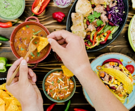 Mexican food table with hands grabbing food