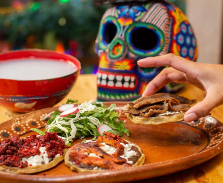 Hand takes Mexican appetizer from plate