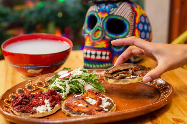 Hand takes Mexican appetizer from plate