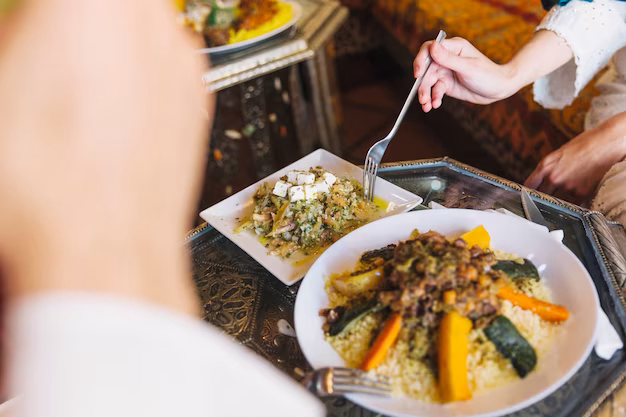 A girl with a fork in her hand eats a salad