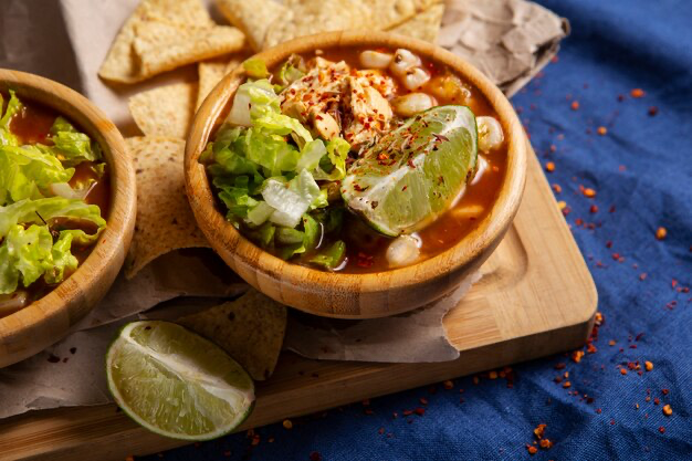 Mexican dish on a board with lime and tacos
